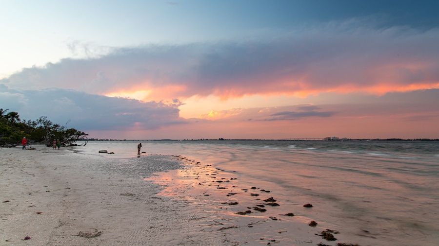 Sanibel Island Lighthouse which includes general coastal views, a sunset and a sandy beach