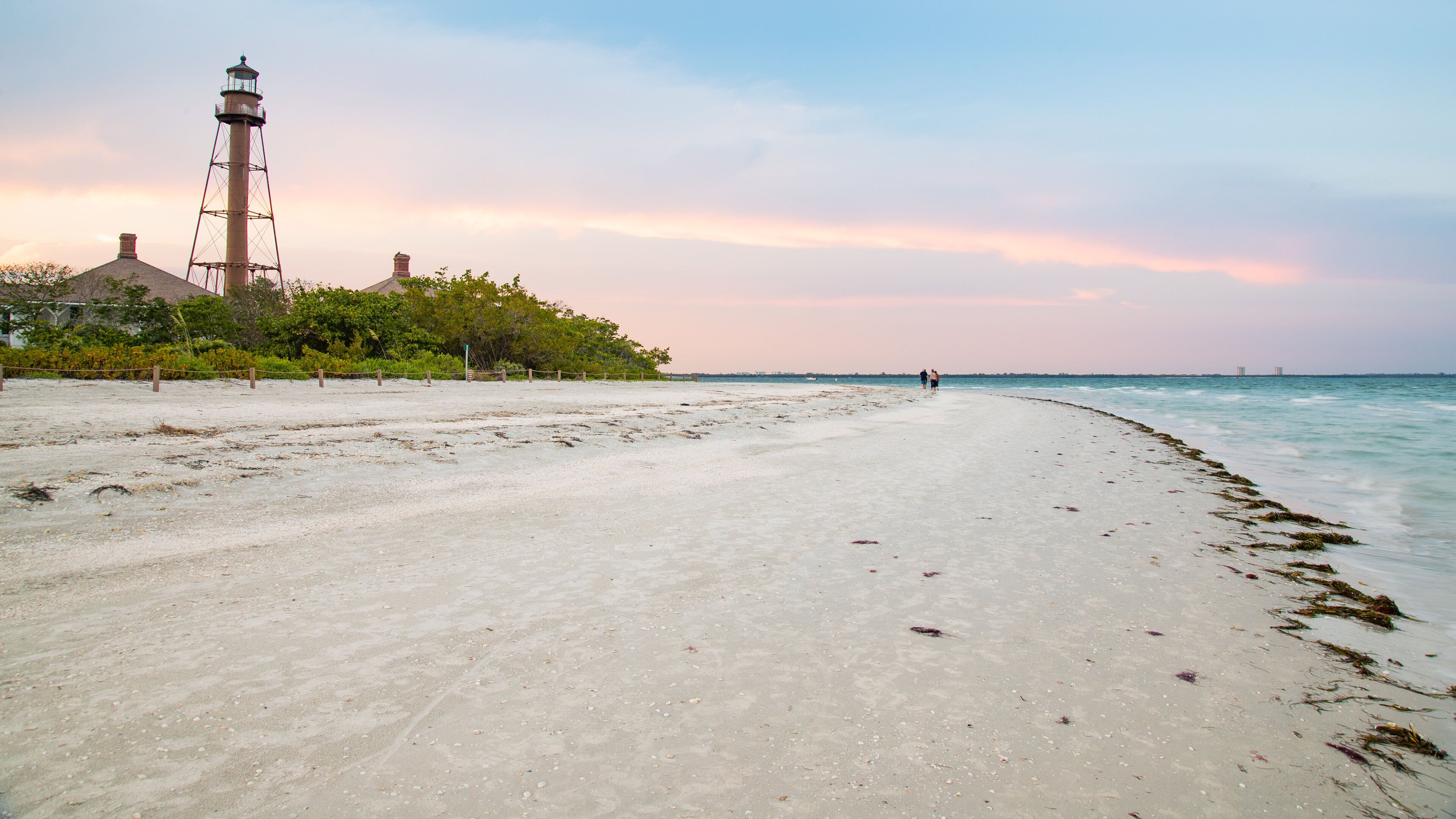 Sanibel Island Lighthouse featuring a beach, general coastal views and a sunset