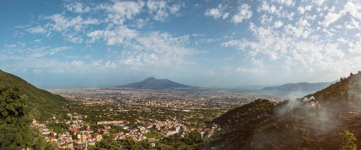 A cityscape with a mountain in the background.