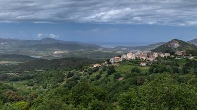 A mountainous landscape with a village nestled among the hills.