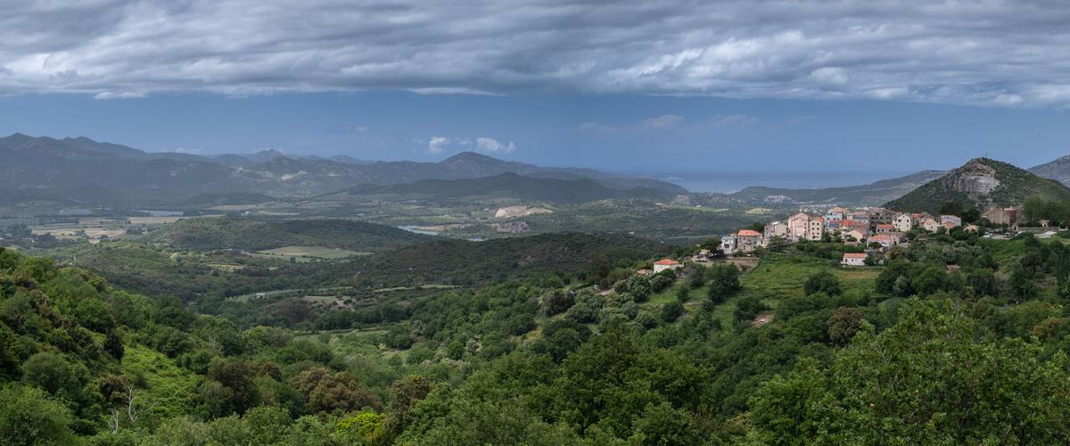 A mountainous landscape with a village nestled among the hills.