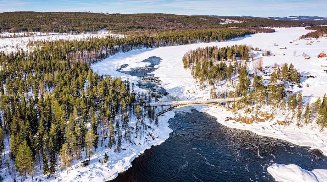 Aerial view of bridge above the scenic Jockfall waterfall in winter, Overkalix, Norrbotten county, Lapland, Sweden, Scandinavia, Europe
