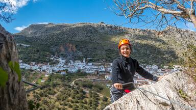 Woman climbing a via ferrata