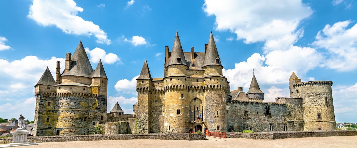 A medieval castle with multiple towers and a large entrance gate.