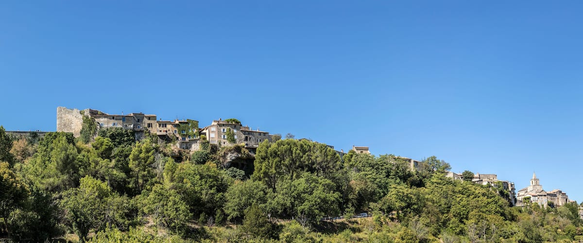 A hillside village with historic stone buildings and a church.
