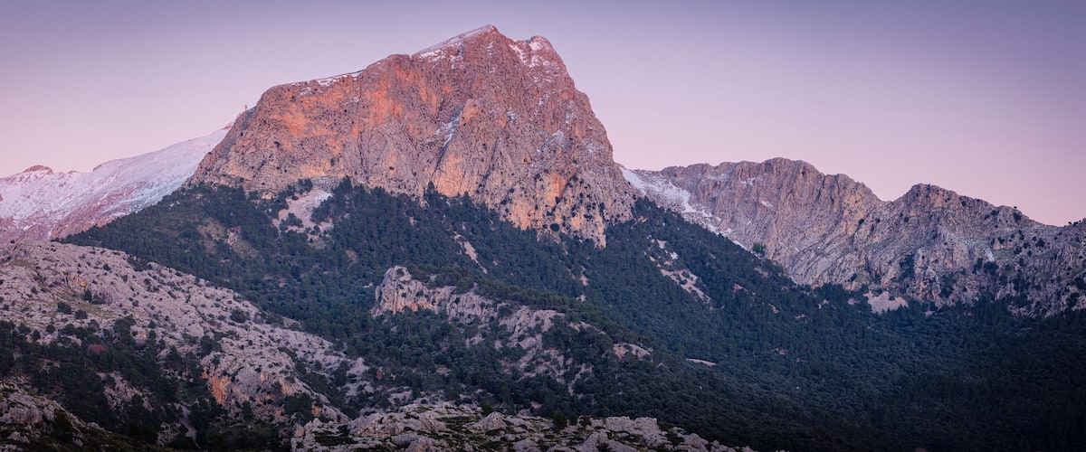 A rugged mountain range with a prominent peak.