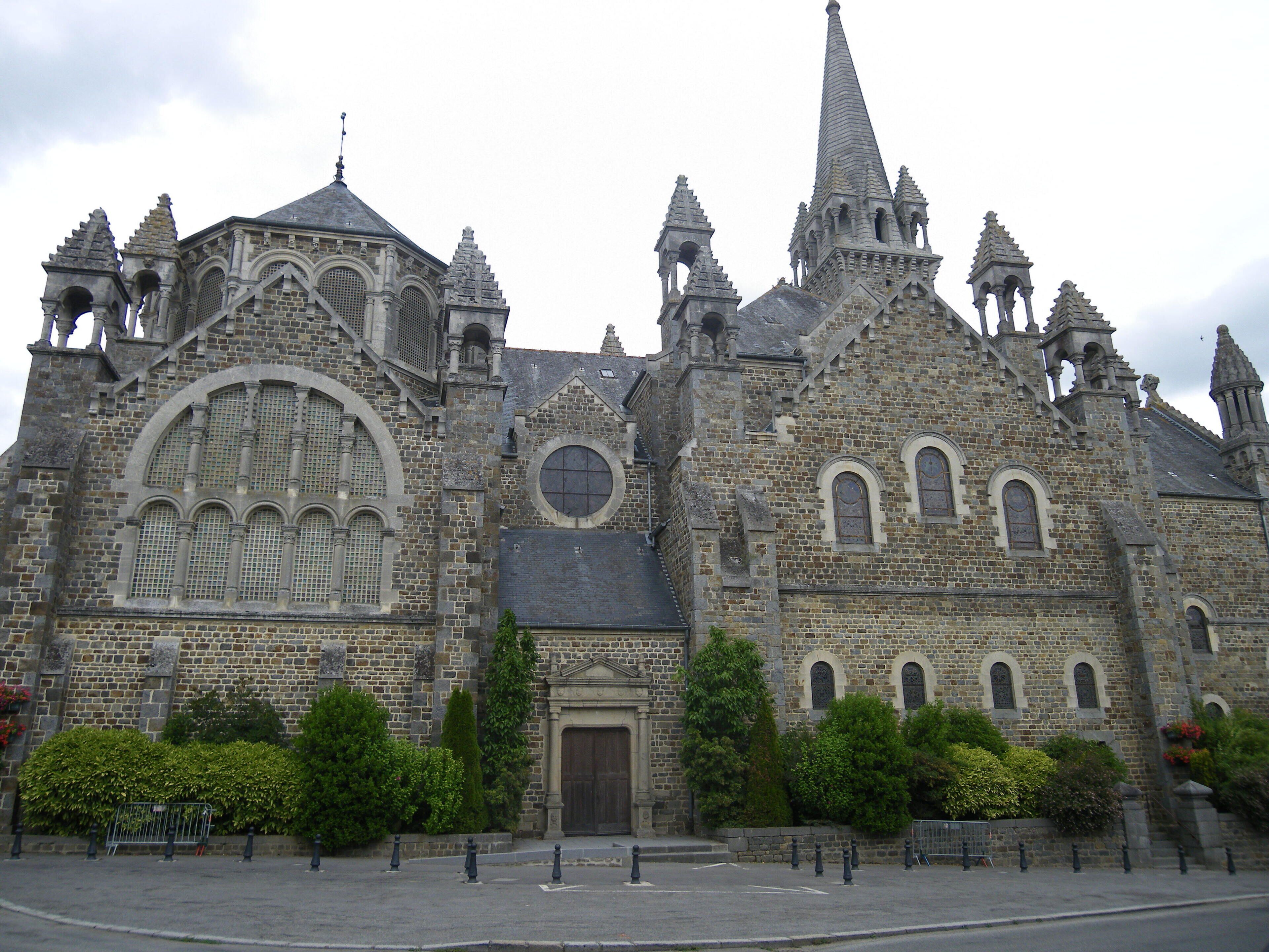 A historic church with intricate stone architecture, multiple spires, and a prominent central dome.