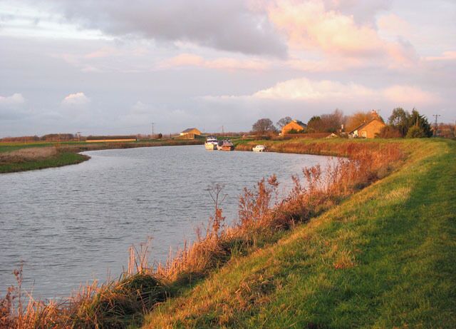 The River Great Ouse in low December sunshine The warm light created by the low December sunshine is deceiving - it is not as warm as it might appear to be from the picture. The Fen Rivers Way long distance footpath leads along here.