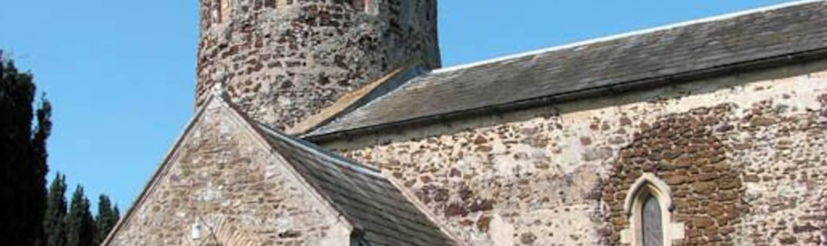 St Mary's church - tower and porch St Mary's is judged by architectural historians to be of Saxon origin. The church is built of carstone and flint and has a round tower with an octagonal top, believed to once have been higher. Interestingly, the tower has no stairs as in very early times ladders were used to access the upper floors which explains the doorways in the east and west walls. An archway of Saxon construction links the tower to the nave. The font dates from the 14th century. There are two Saxon windows in the north and south walls. During the 19th century the windows were changed - a lancet window was being put in the north wall and on the south side two early English and Perpendicular windows were blocked up and another lancet window was added where there had been an early English window. The church was restored and the floor was retiled during Victorian times.