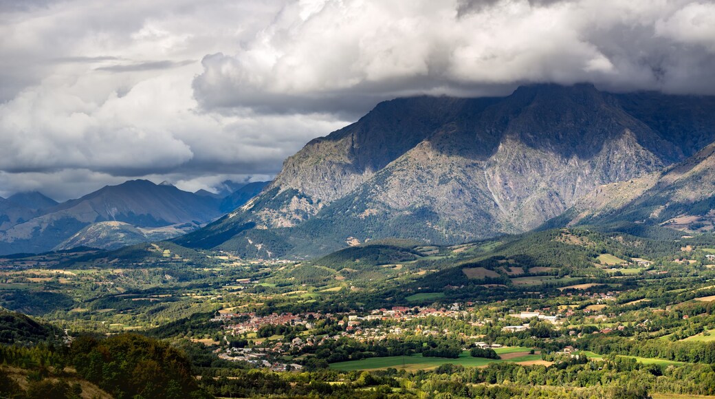 Saint Bonnet en Champsaur and the Petit Chaillol mountain peak in the clouds. Summer in the Southern French Alps. Hautes-Alpes, PACA Region, Champsaur, France