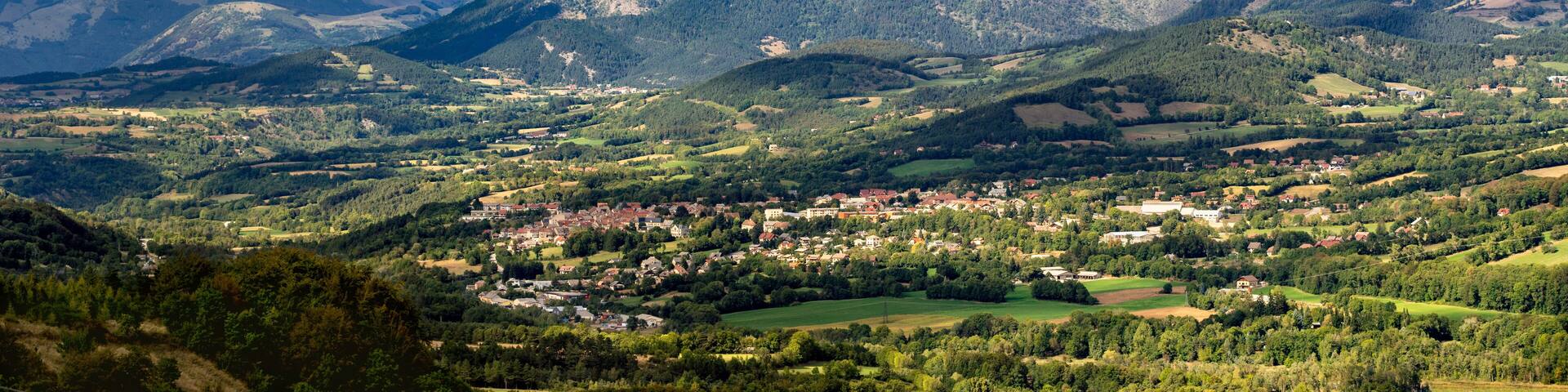 Saint Bonnet en Champsaur and the Petit Chaillol mountain peak in the clouds. Summer in the Southern French Alps. Hautes-Alpes, PACA Region, Champsaur, France