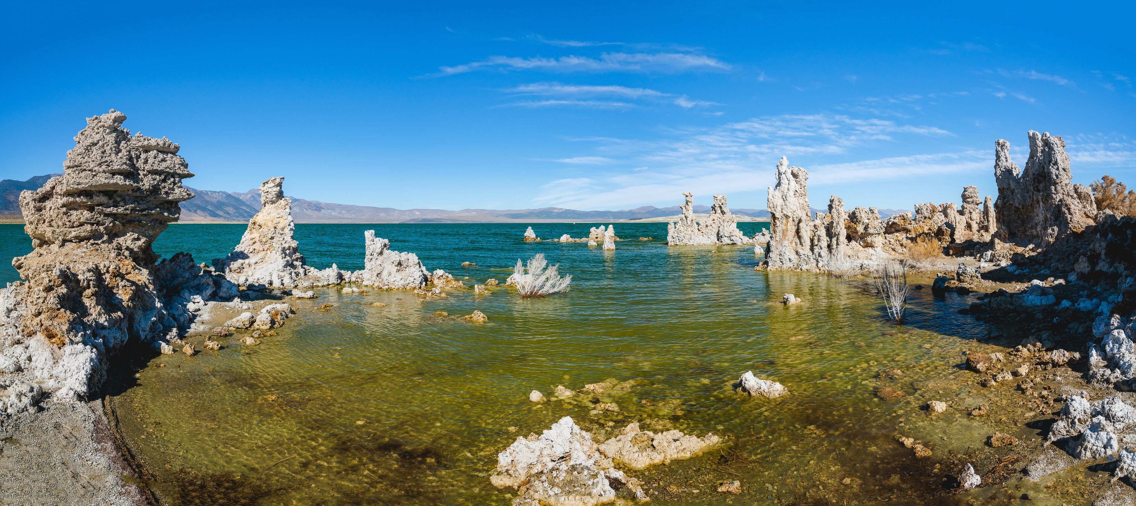 A clear lake surrounded by rocky formations.