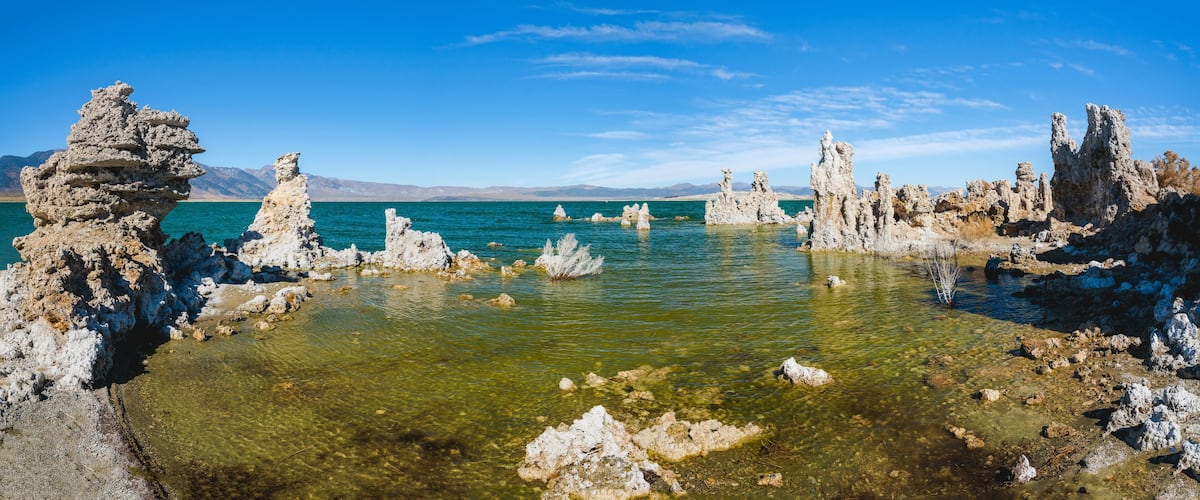 A clear lake surrounded by rocky formations.