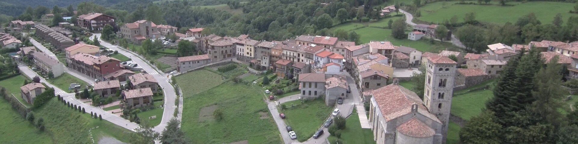 A historic town with medieval architecture, including a prominent tower and fortified walls.