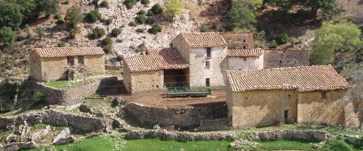 A rural village with stone houses and terraced fields.