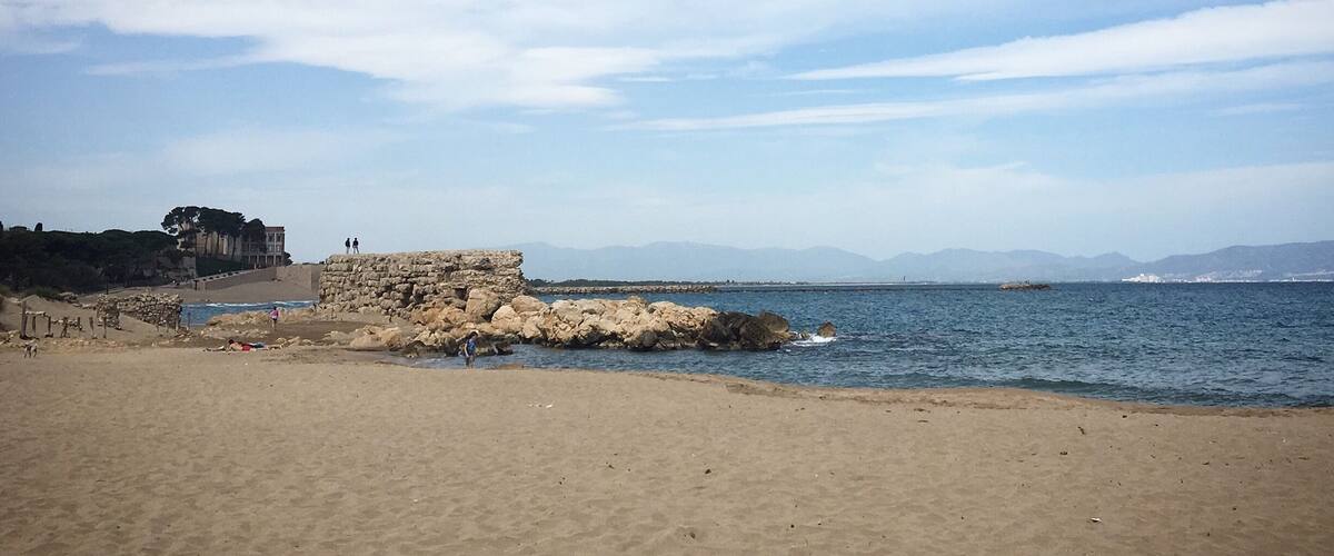 The coast near the Mediterranean village Sant Martí d’Empúries. On the other side of the  bay where you can see the outline of mountains and houses is coast of Roses.