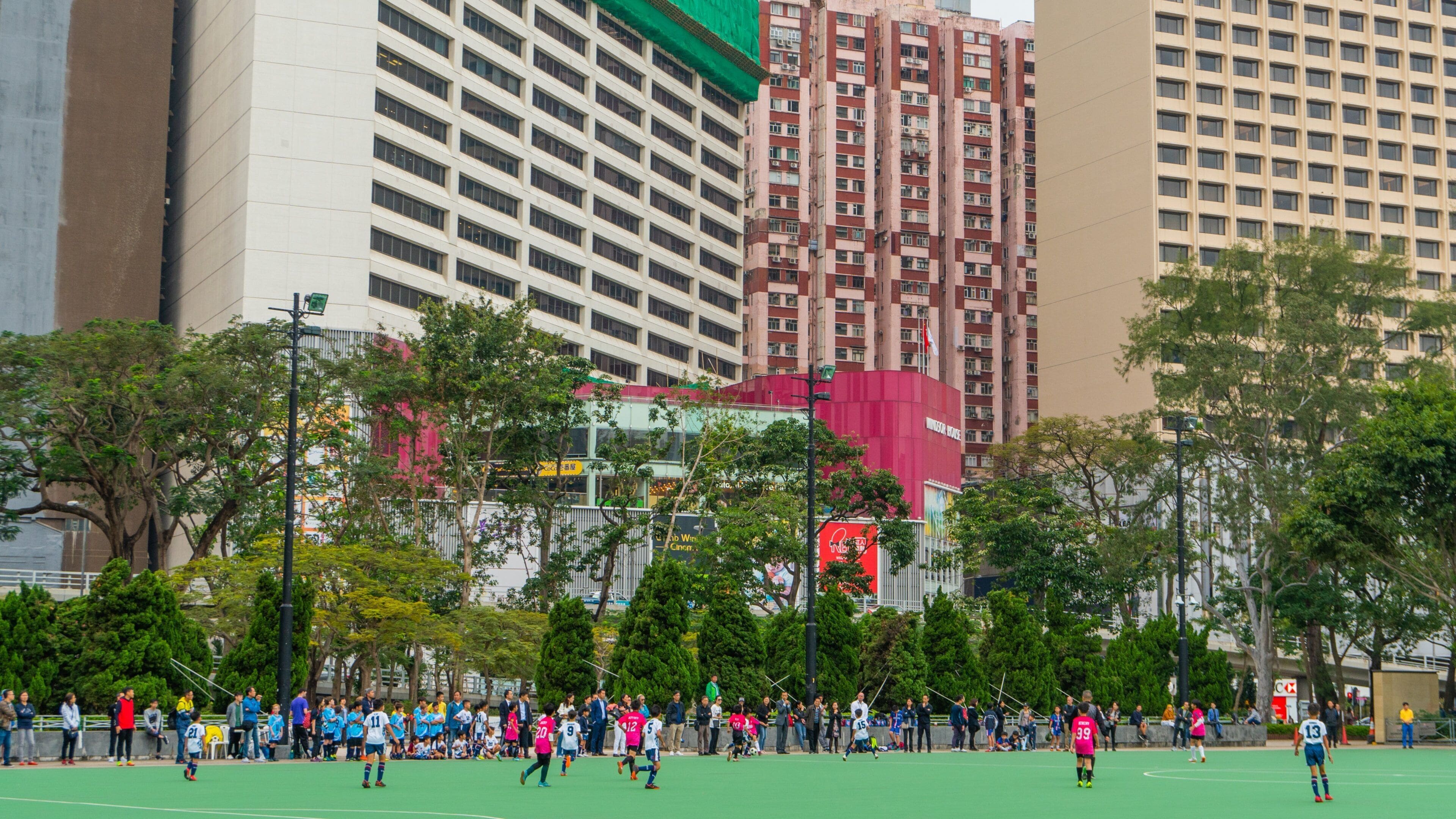 Victoria Park showing a sporting event as well as a small group of people