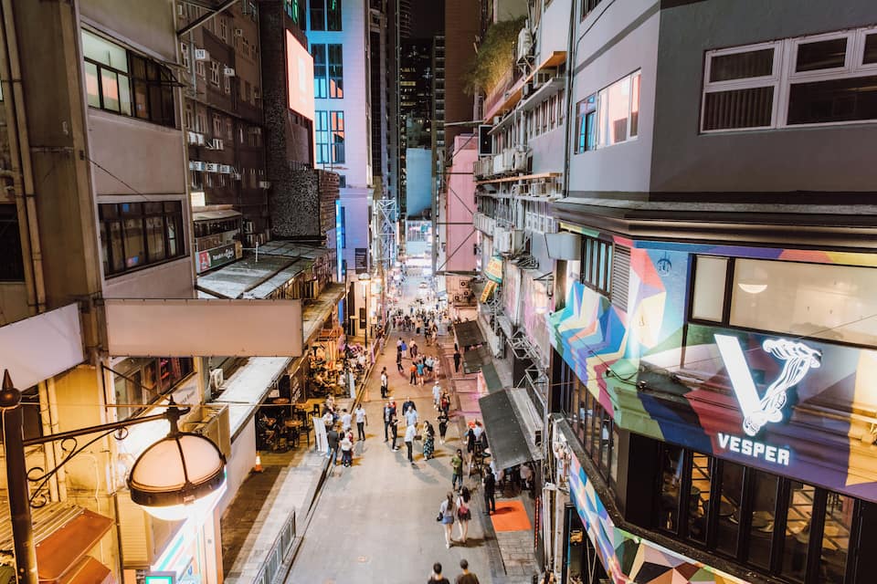 A bustling urban street with shops and restaurants.