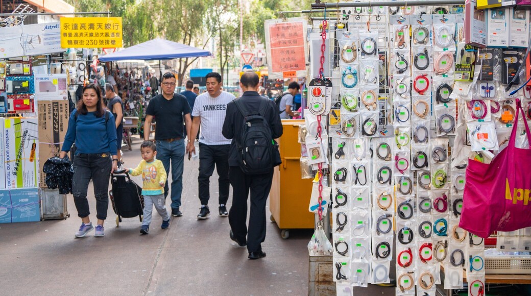 Apliu Street Market showing markets and street scenes as well as a small group of people