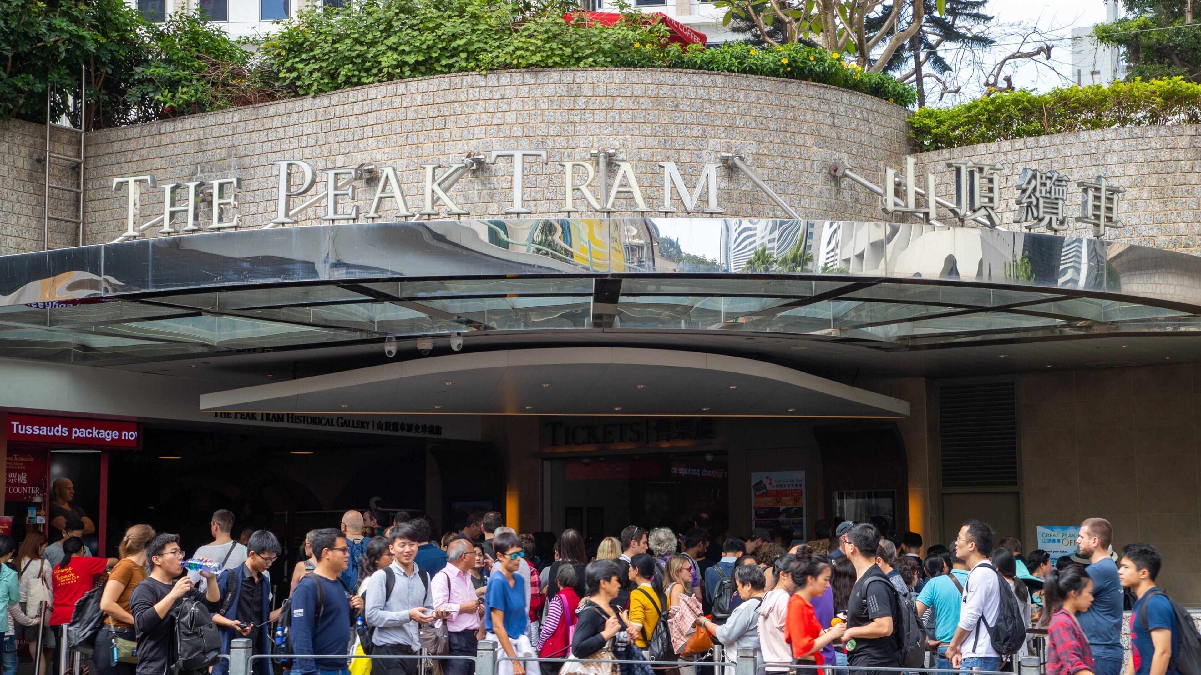 The Peak Tram featuring signage and street scenes as well as a large group of people