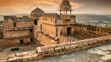 A historic fort with a large dome and a smaller pavilion, surrounded by a high wall and a moat.
