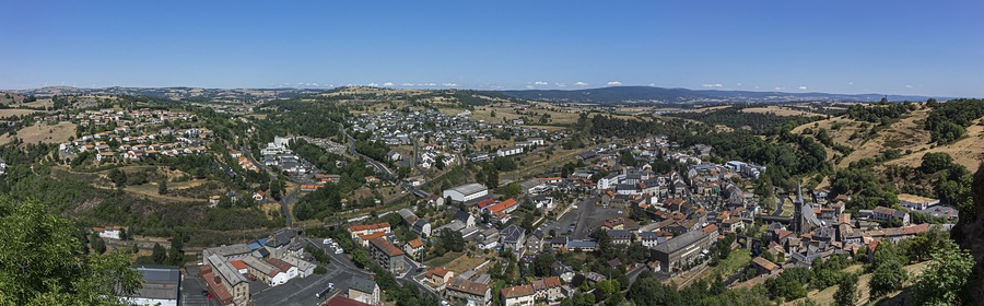 Picturesque view of Saint-Flour (Sant Flor) lower town. Ander and Margeride mountains in the background. Saint-Flour, Cantal department, Auvergne region, France.