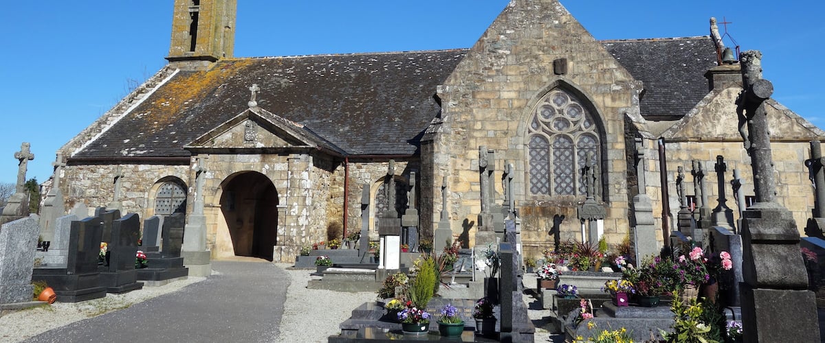 A historic church with a tall spire and a large arched entrance.