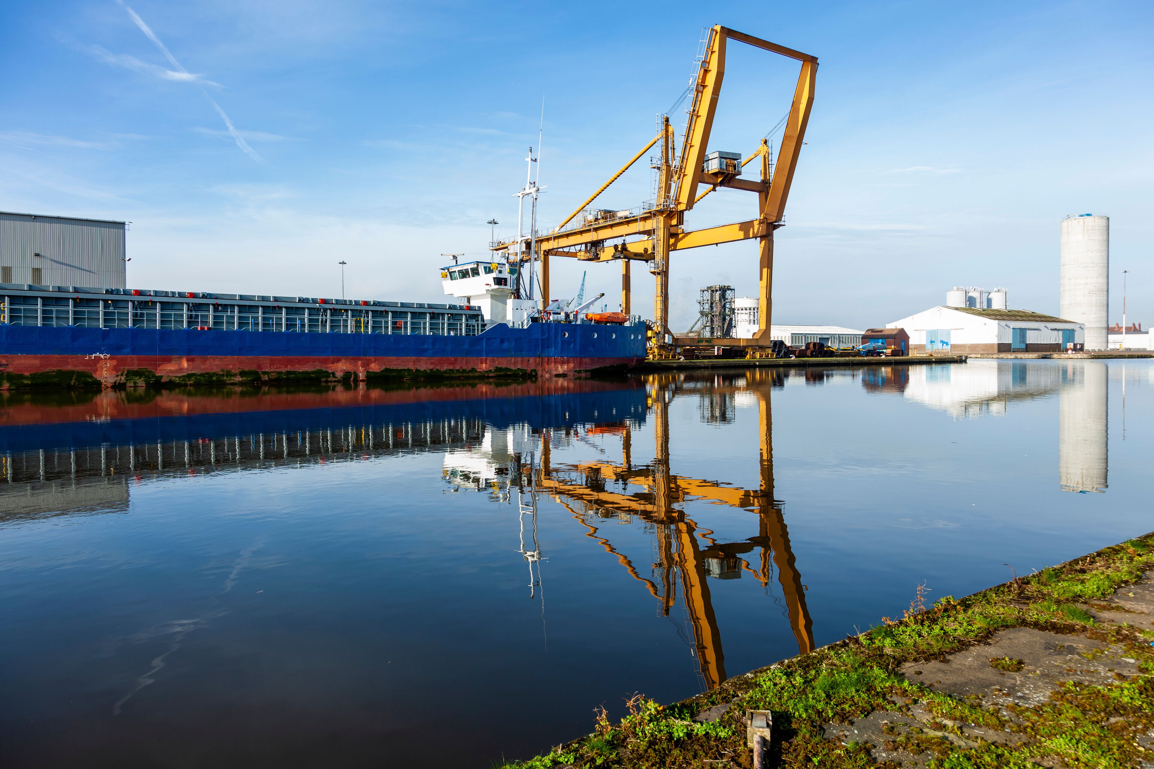 Blue ship in dock and refection.