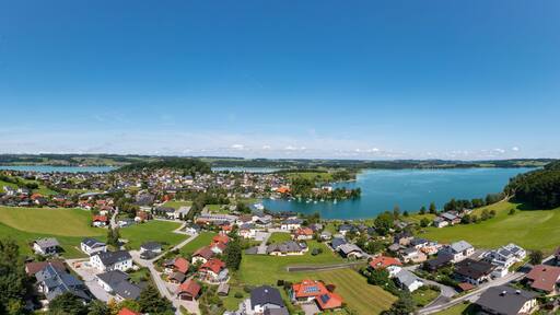 Austria, Salzburg, Mattsee, Drone panorama of lakeshore town in summer