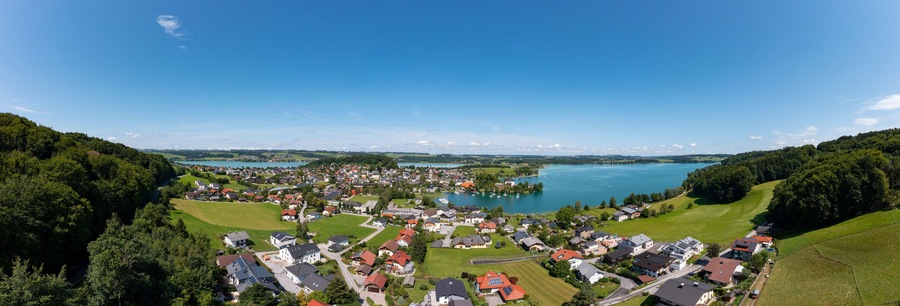 Austria, Salzburg, Mattsee, Drone panorama of lakeshore town in summer