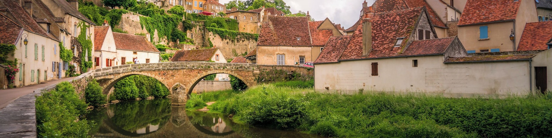 Semur-en-Auxois is a pictures village in the Côte-d'Or department in eastern France. Here is the iconic view with the bridge over the River Armançon and the historic center at the back.
