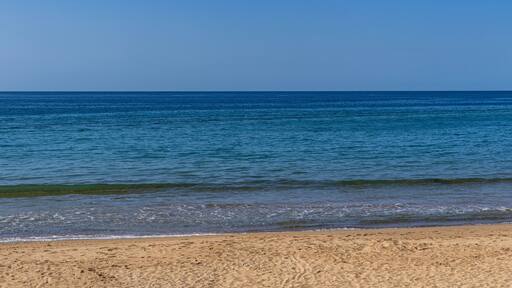 Calm Mediterranean beach with golden sand and blue sea in northern Morocco