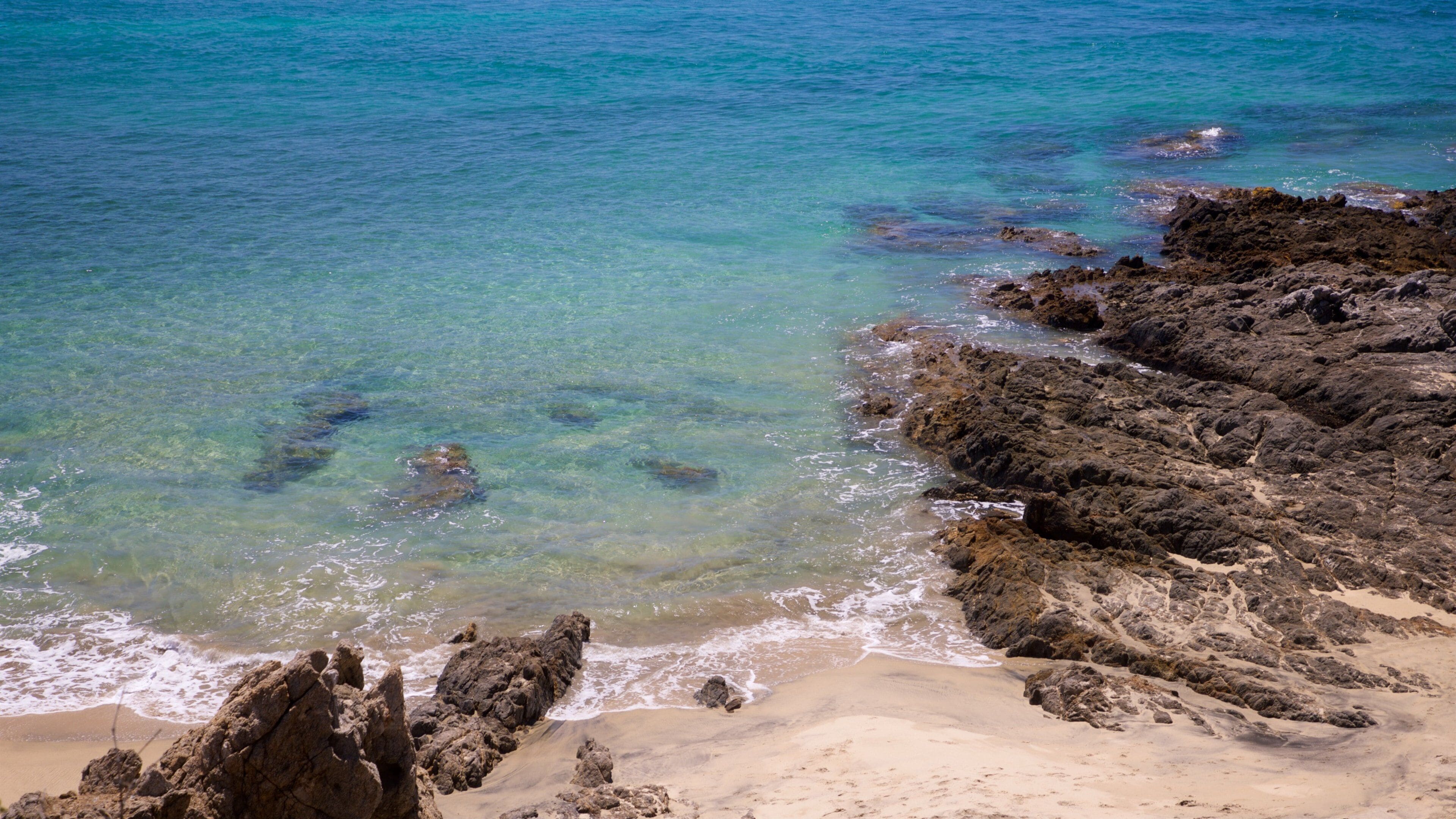 Todos Santos featuring general coastal views, rocky coastline and a beach