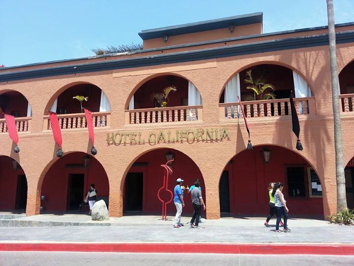 A building with arched windows and the sign "Hotel California".