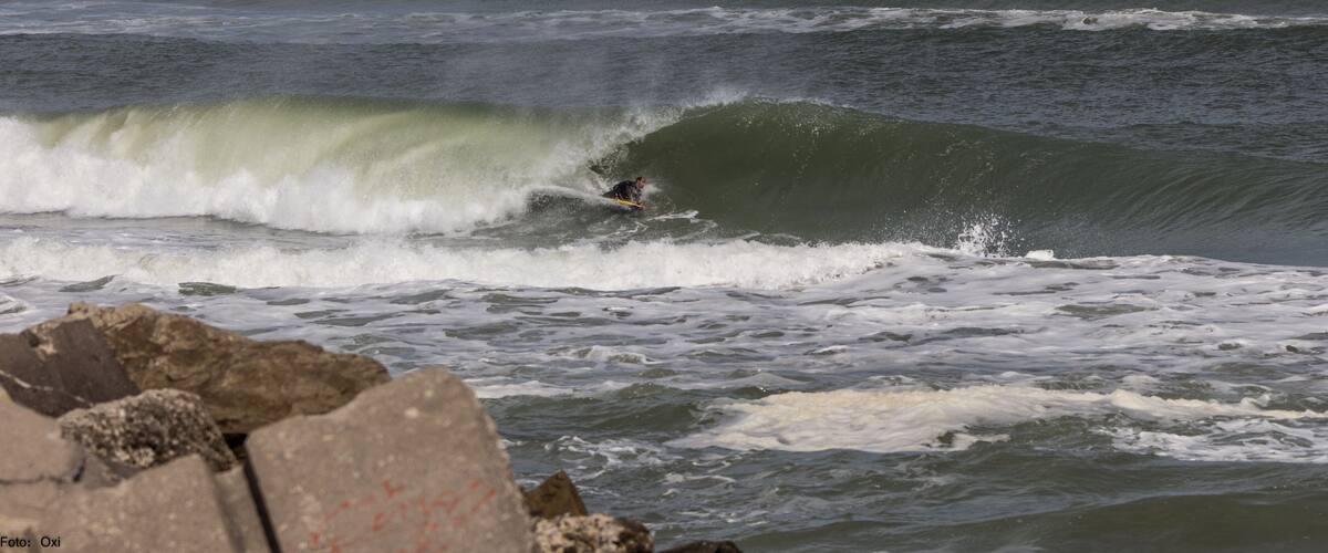 A surfer riding a large wave in the ocean.