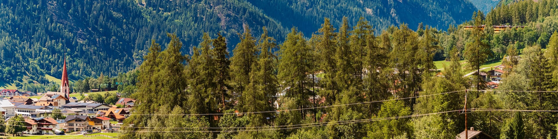 Alpine summer view with a church at Umhausen, Imst, Oetztal valley, Tyrol, Austria