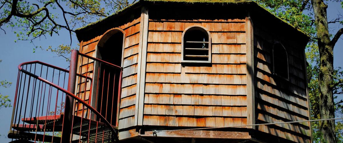A wooden tower with a staircase and a small window.