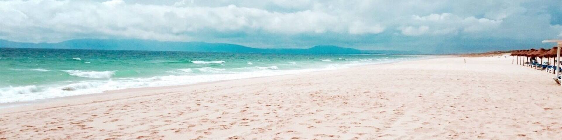 Comporta is a village on the Tróia peninsula, a 13-mile long sandy spit in the north of Portugal's Alentejo region. It sits at the heel of the peninsula, at the southern end of the wide Sado estuary, sandwiched between dense forest and the Atlantic. The village is lovely and has affordable places to stay. You can get in that place by ferry from Setúbal to Tróia.