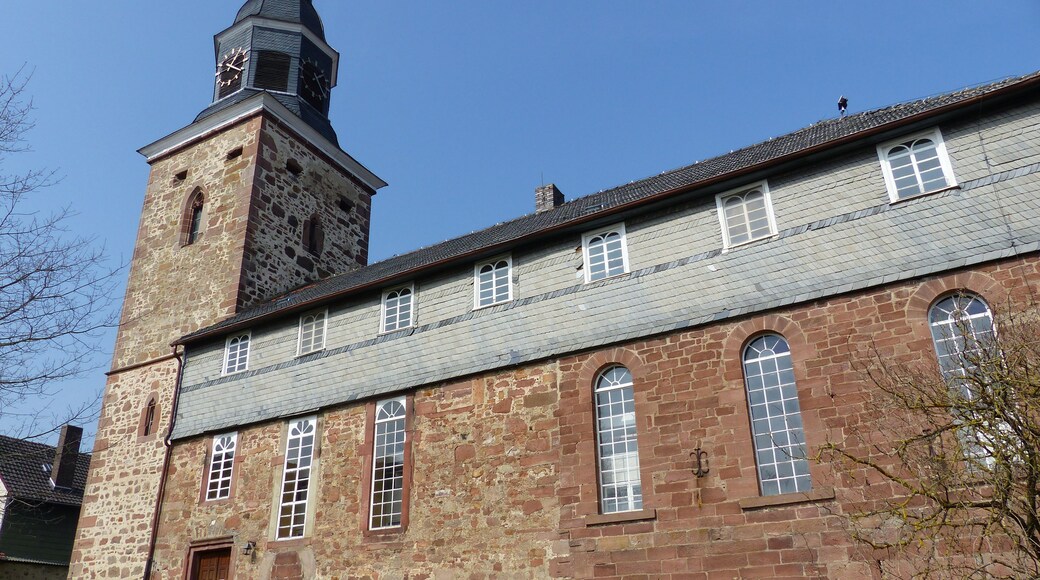 A historic church with a prominent tower and arched windows.