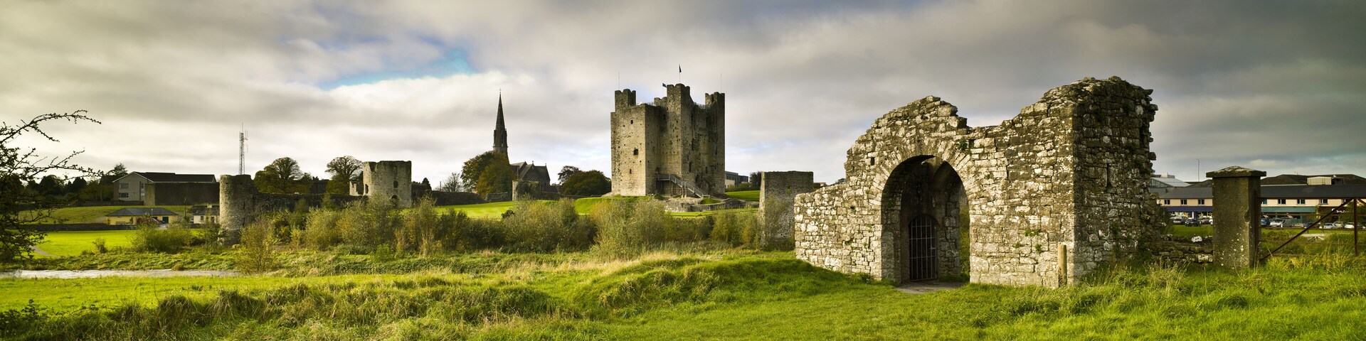 Trim Castle Trim, County Meath, Ireland. Green grass and cloudy sky. Morning.