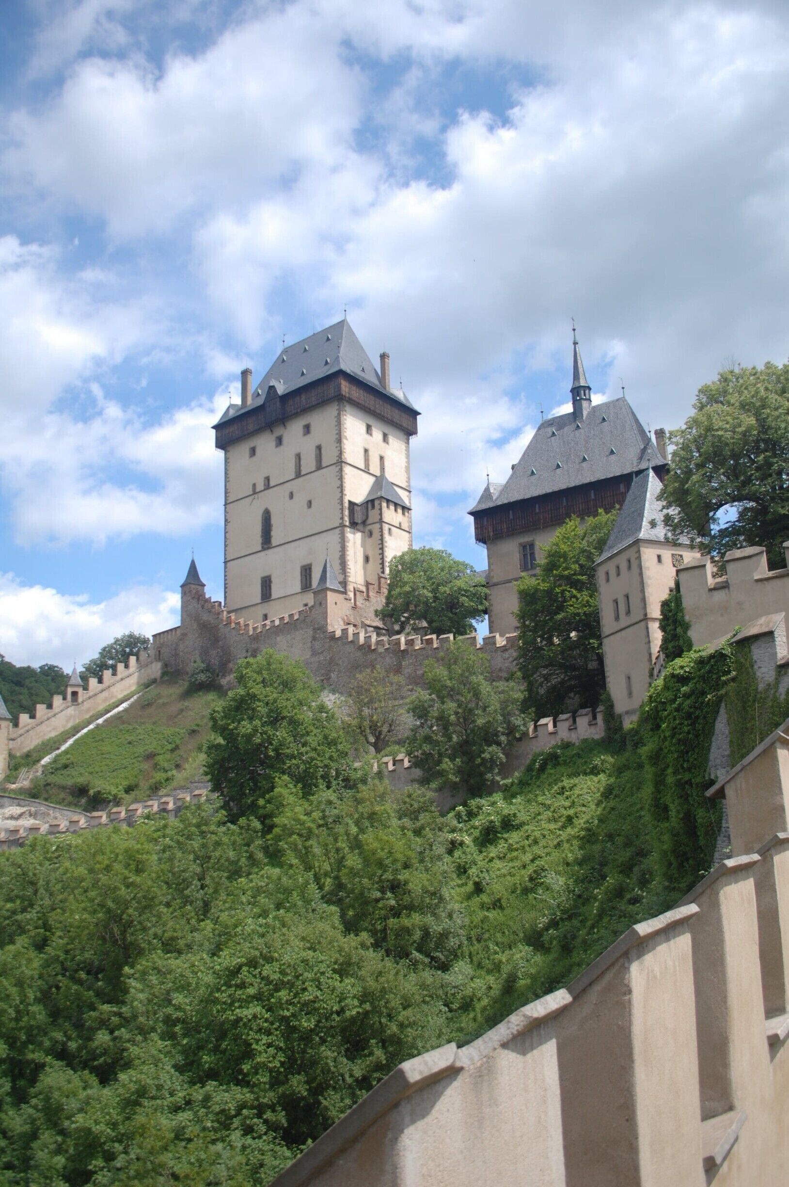 Karlštejn is a small village around 30 km southwest of Prague, and is an easy half day trip.
The main (and probably only) attraction is the impressive 14th century Gothic castle.
http://www.greengoulash.com/prague-day-trips/