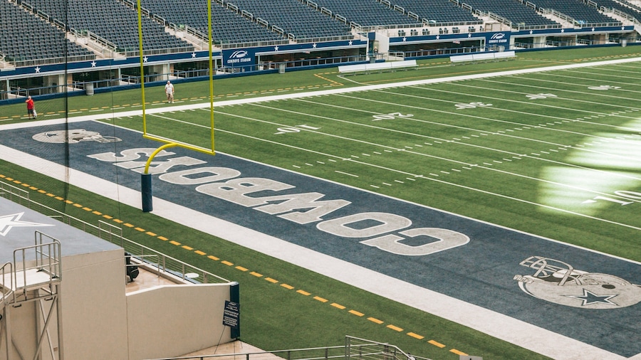 A football stadium with the Cowboys logo on the field.