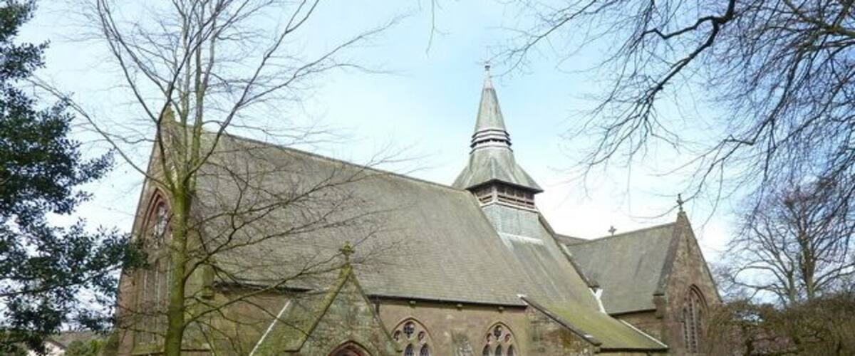 A historic church with a pointed steeple and arched windows.
