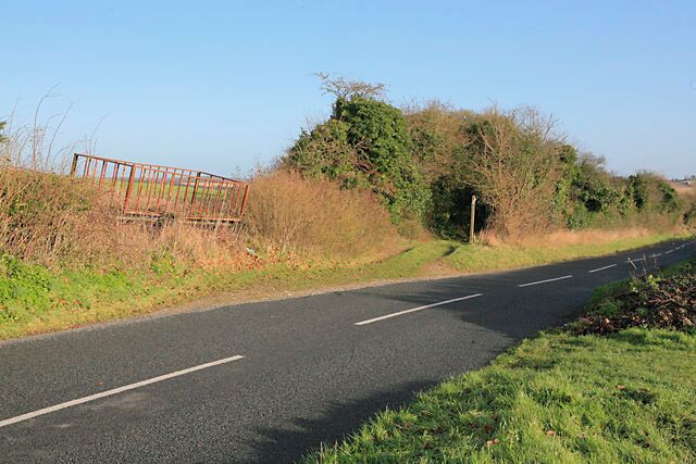 Wayfarer's Walk joins the road above Totford The Wayfarer's Walk crosses the B3046 at Totford (off picture right), follows this road up hill from the right, and doubles back on itself here. The farm truck seems to be doing its best to become part of the hedge.