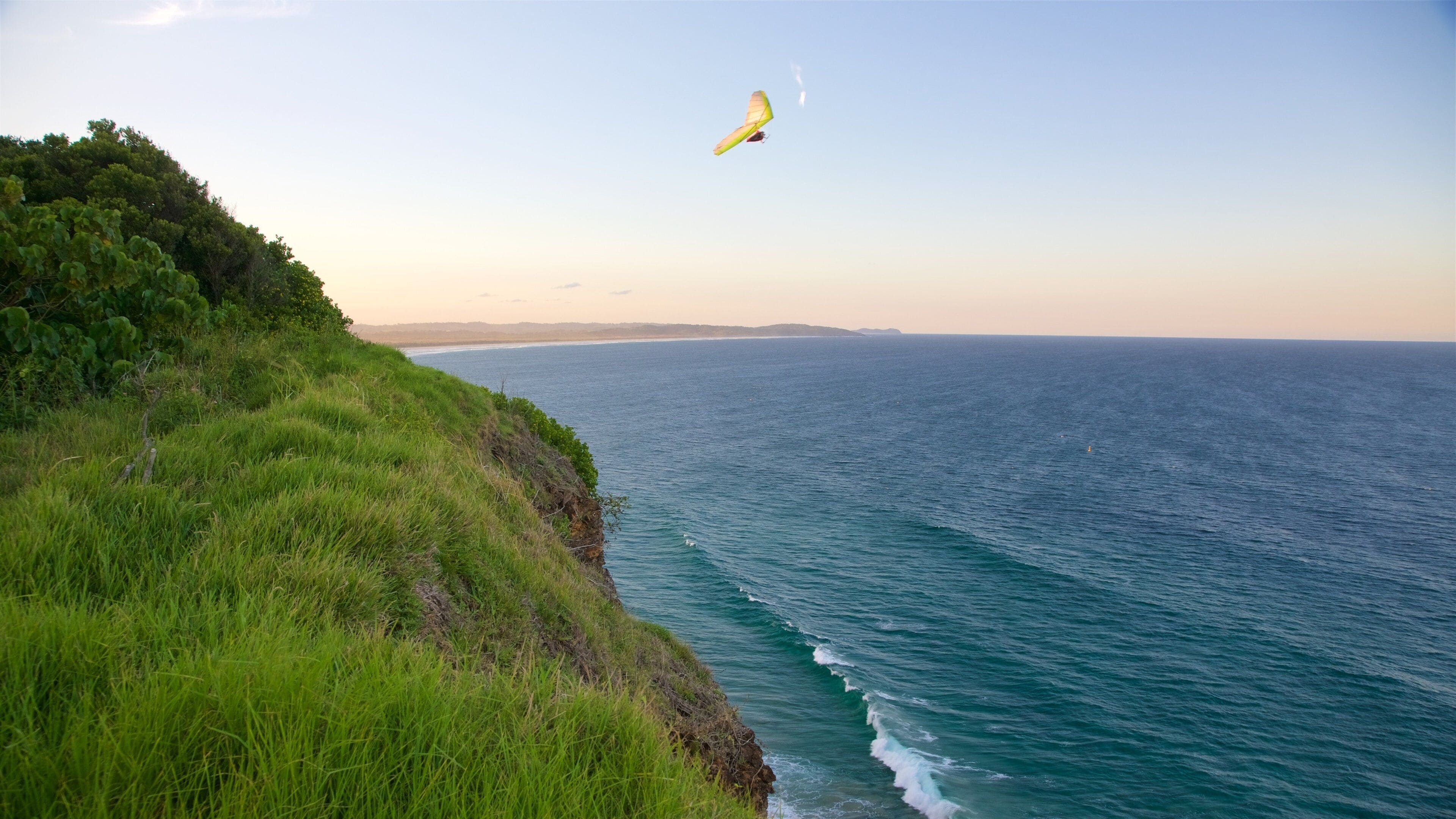 Lennox Head showing rocky coastline and parasailing