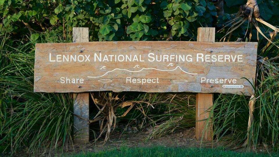 A wooden sign for Lennox National Surfing Reserve with the words "Share," "Respect," and "Preserve" etched on it.