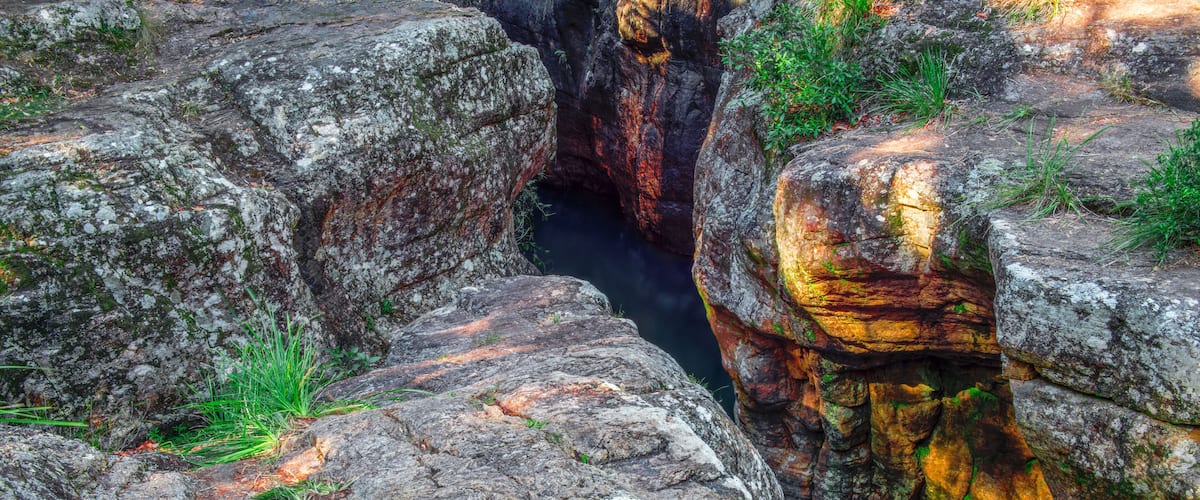 A rocky canyon with a narrow water channel.