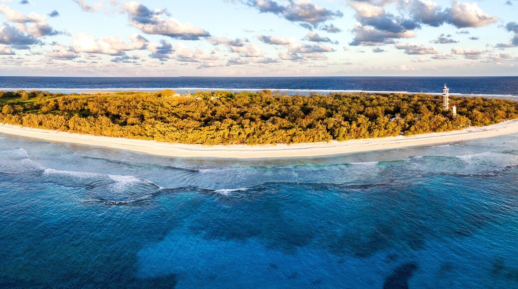 Aerial view of Lady Elliot Island in Queensland Australia with the coral reef in the foreground and clouds in the background.