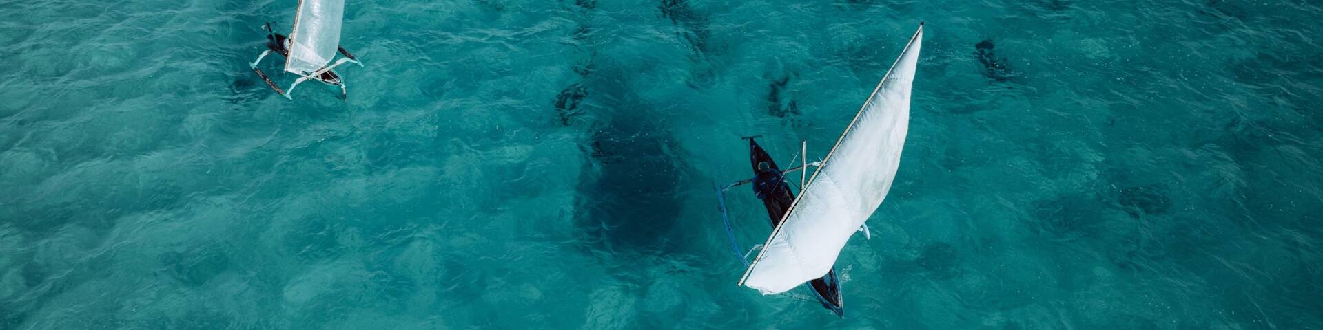 Dhow sailboats on turquoise waters