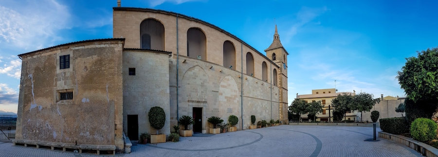 A historic building with arched windows and a clock tower.